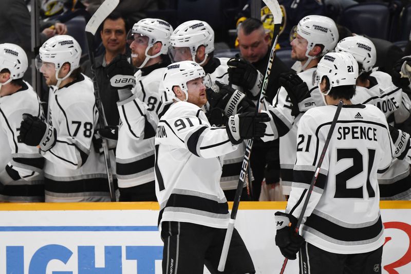 Jan 31, 2024; Nashville, Tennessee, USA; Los Angeles Kings right wing Carl Grundstrom (91) is congratulated by teammates after a goal during the first period against the Nashville Predators at Bridgestone Arena. Mandatory Credit: Christopher Hanewinckel-USA TODAY Sports