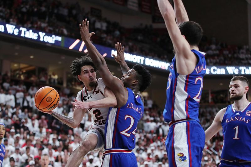 Feb 12, 2024; Lubbock, Texas, USA;  Texas Tech Red Raiders guard Pop Isaacs (2) pass the ball around Kansas Jayhawks KJ Admas Jr. (24) in the second half at United Supermarkets Arena. Mandatory Credit: Michael C. Johnson-USA TODAY Sports