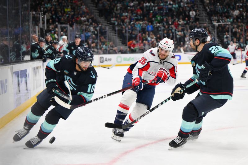 Mar 14, 2024; Seattle, Washington, USA; Seattle Kraken center Matty Beniers (10) plays the puck while defended by Washington Capitals right wing Nic Dowd (26) during the third period at Climate Pledge Arena. Mandatory Credit: Steven Bisig-USA TODAY Sports