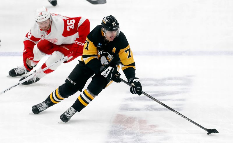 Mar 17, 2024; Pittsburgh, Pennsylvania, USA;  Pittsburgh Penguins center Evgeni Malkin (71) moves the puck against Detroit Red Wings right wing Christian Fischer (36) during the third period at PPG Paints Arena. Pittsburgh won 6-3. Mandatory Credit: Charles LeClaire-USA TODAY Sports