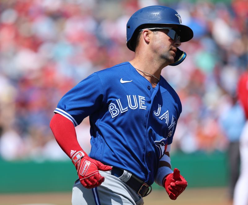 Mar 12, 2023; Clearwater, Florida, USA; Toronto Blue Jays outfielder Whit Merrifield (15) singles against the Philadelphia Phillies during the second inning at BayCare Ballpark. Mandatory Credit: Kim Klement-USA TODAY Sports