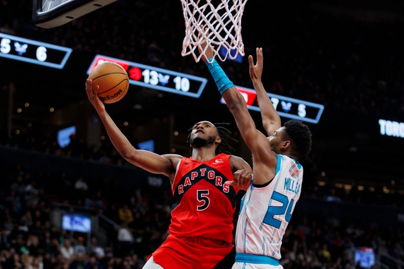 TORONTO, CANADA - MARCH 3: Immanuel Quickley #5 of the Toronto Raptors drives to the net against Brandon Miller #24 of the Charlotte Hornets in the first half of their NBA game at Scotiabank Arena on March 3, 2024 in Toronto, Canada. NOTE TO USER: User expressly acknowledges and agrees that, by downloading and or using this photograph, User is consenting to the terms and conditions of the Getty Images License Agreement. (Photo by Cole Burston/Getty Images)