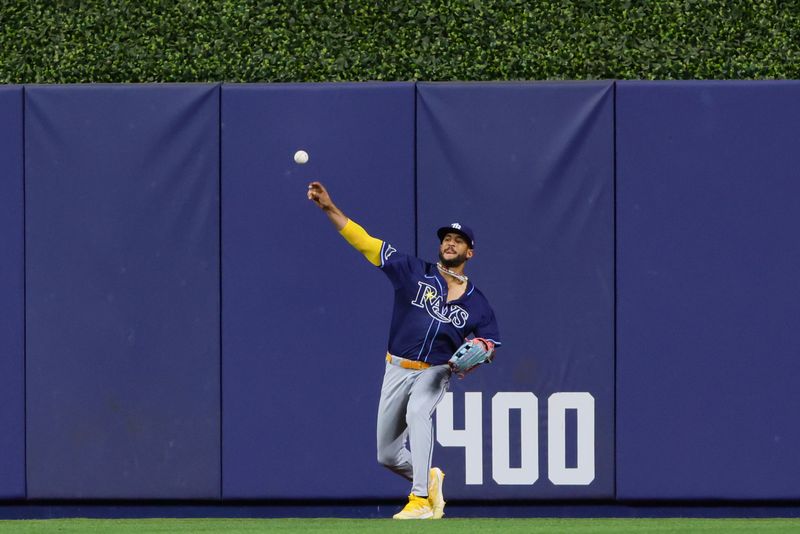 Jun 5, 2024; Miami, Florida, USA; Tampa Bay Rays center fielder Jose Siri (22) throws the baseball after making a catch against Miami Marlins left fielder Bryan De La Cruz (not pictured) during the eighth inning at loanDepot Park. Mandatory Credit: Sam Navarro-USA TODAY Sports