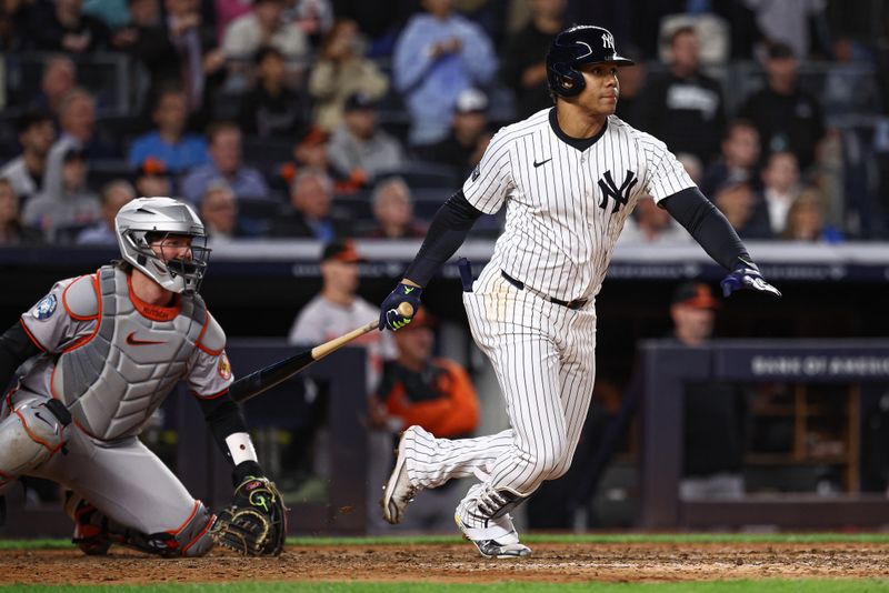 Sep 24, 2024; Bronx, New York, USA; New York Yankees right fielder Juan Soto (22) hits an RBI single during the seventh inning against the Baltimore Orioles at Yankee Stadium. Mandatory Credit: Vincent Carchietta-Imagn Images