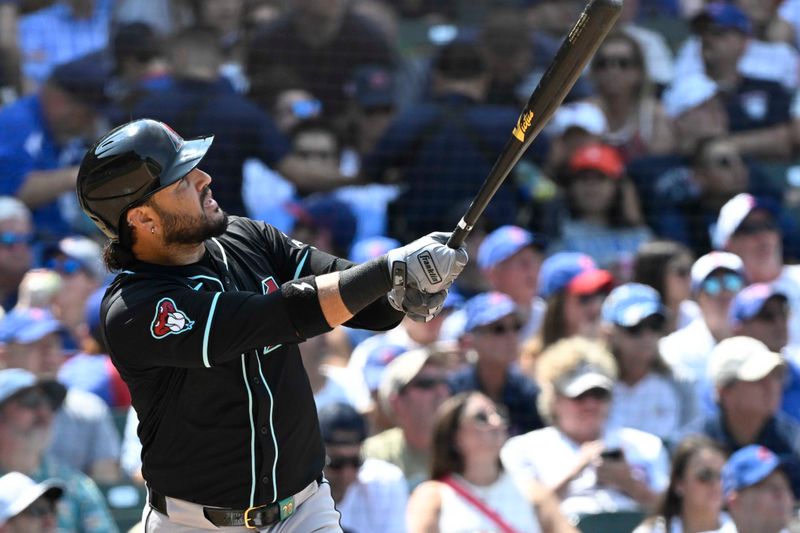 Jul 21, 2024; Chicago, Illinois, USA;  Arizona Diamondbacks third baseman Eugenio Suárez watches his home run against the Chicago Cubs during the seventh inning at Wrigley Field. Mandatory Credit: Matt Marton-USA TODAY Sports