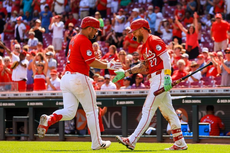 Sep 5, 2024; Cincinnati, Ohio, USA; Cincinnati Reds first baseman Ty France (2) high fives outfielder Jake Fraley (27) after hitting a solo home run in the seventh inning against the Houston Astros at Great American Ball Park. Mandatory Credit: Katie Stratman-Imagn Images