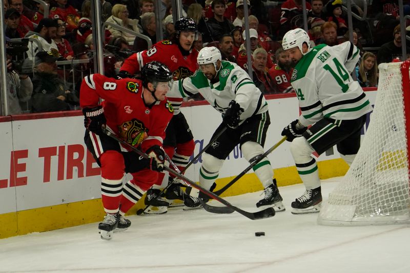 Nov 27, 2024; Chicago, Illinois, USA; Chicago Blackhawks center Ryan Donato (8) and Dallas Stars left wing Jamie Benn (14) go for the puck during the first period at United Center. Mandatory Credit: David Banks-Imagn Images