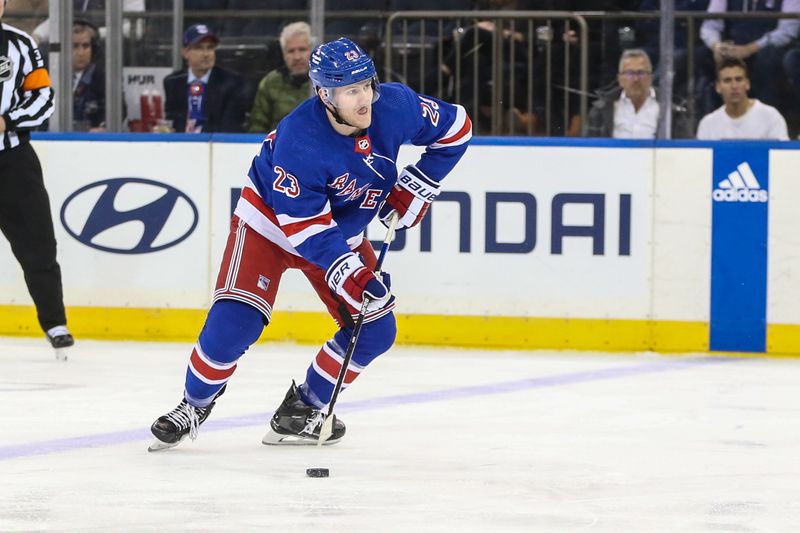 Jan 8, 2024; New York, New York, USA;  New York Rangers defenseman Adam Fox (23) controls the puck in the first period against the Vancouver Canucks at Madison Square Garden. Mandatory Credit: Wendell Cruz-USA TODAY Sports