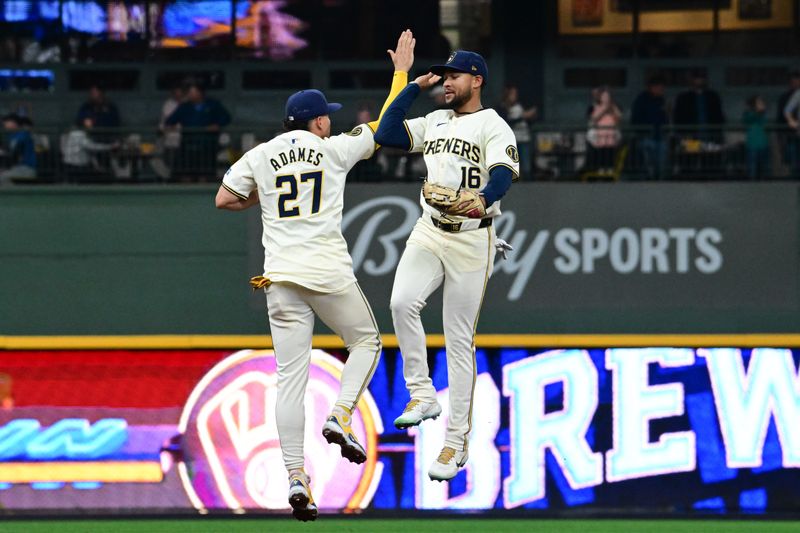 Apr 17, 2024; Milwaukee, Wisconsin, USA; Milwaukee Brewers shortstop Willy Adames (27) and center fielder Blake Perkins (16) celebrate after beating the San Diego Padres at American Family Field. Mandatory Credit: Benny Sieu-USA TODAY Sports