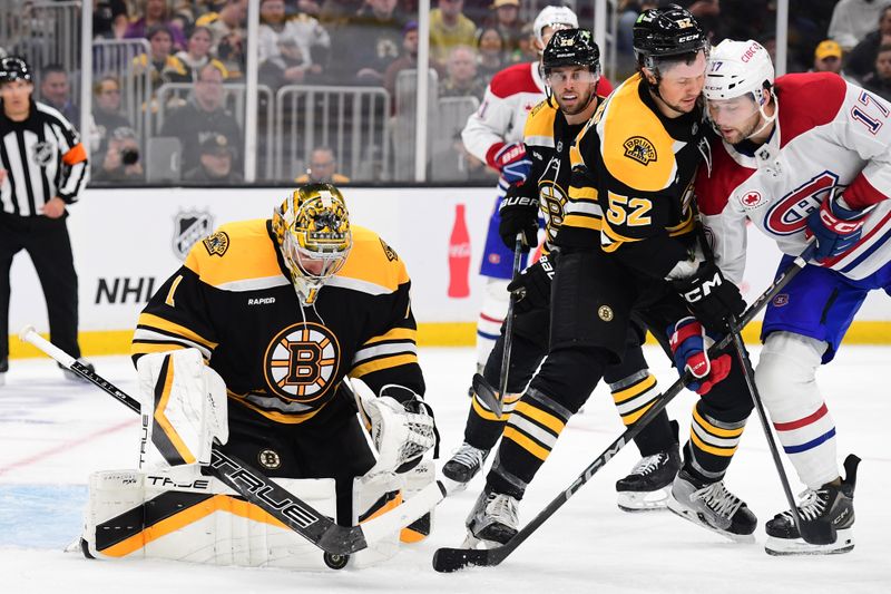 Oct 10, 2024; Boston, Massachusetts, USA; Boston Bruins goaltender Jeremy Swayman (1) makes a save in front of defenseman Andrew Peeke (52) and Montreal Canadiens right wing Josh Anderson (17) during the second period at TD Garden. Mandatory Credit: Bob DeChiara-Imagn Images