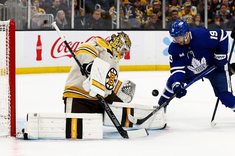 Mar 7, 2024; Boston, Massachusetts, USA; Boston Bruins goaltender Jeremy Swayman (1) makes a save as Toronto Maple Leafs center Calle Jarnkrok (19) battles for the reebound during the second period at TD Garden. Mandatory Credit: Winslow Townson-USA TODAY Sports