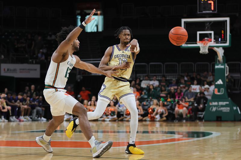 Feb 24, 2024; Coral Gables, Florida, USA; Georgia Tech Yellow Jackets guard Miles Kelly (13) passes the basketball as Miami Hurricanes forward Norchad Omier (15) defends during the first half at Watsco Center. Mandatory Credit: Sam Navarro-USA TODAY Sports