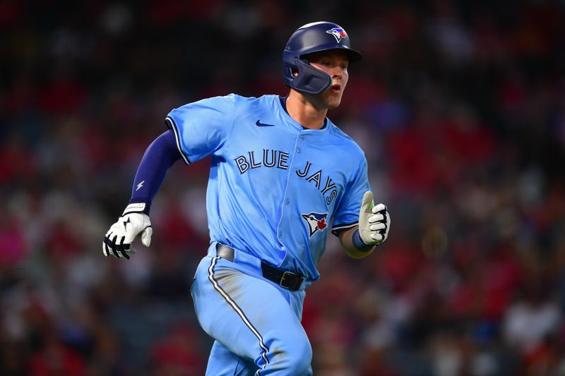 Aug 12, 2024; Anaheim, California, USA; Toronto Blue Jays second baseman Will Wagner (7) runs after hitting a single against the Los Angeles Angels during the fifth inning at Angel Stadium. Mandatory Credit: Gary A. Vasquez-USA TODAY Sports