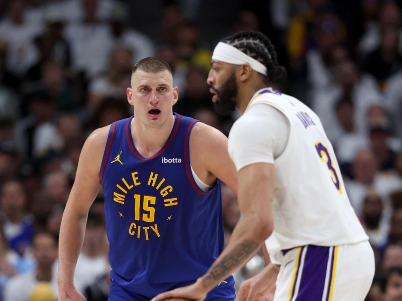 DENVER, COLORADO - APRIL 20: Nikola Jokic #15 of the Denver Nuggets guards Anthony Davis #3 of the Los Angeles Lakers in the third quarter during game one of the Western Conference First Round Playoffs at Ball Arena on April 20, 2024 in Denver, Colorado.  NOTE TO USER: User expressly acknowledges and agrees that, by downloading and or using this photograph, User is consenting to the terms and conditions of the Getty Images License Agreement. (Photo by Matthew Stockman/Getty Images)