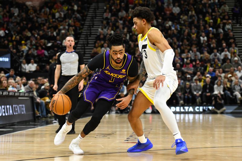 SALT LAKE CITY, UTAH - JANUARY 13: D'Angelo Russell #1 of the Los Angeles Lakers drives into Keyonte George #3 of the Utah Jazz during the second half of a game at Delta Center on January 13, 2024 in Salt Lake City, Utah. NOTE TO USER: User expressly acknowledges and agrees that, by downloading and or using this photograph, User is consenting to the terms and conditions of the Getty Images License Agreement. (Photo by Alex Goodlett/Getty Images)