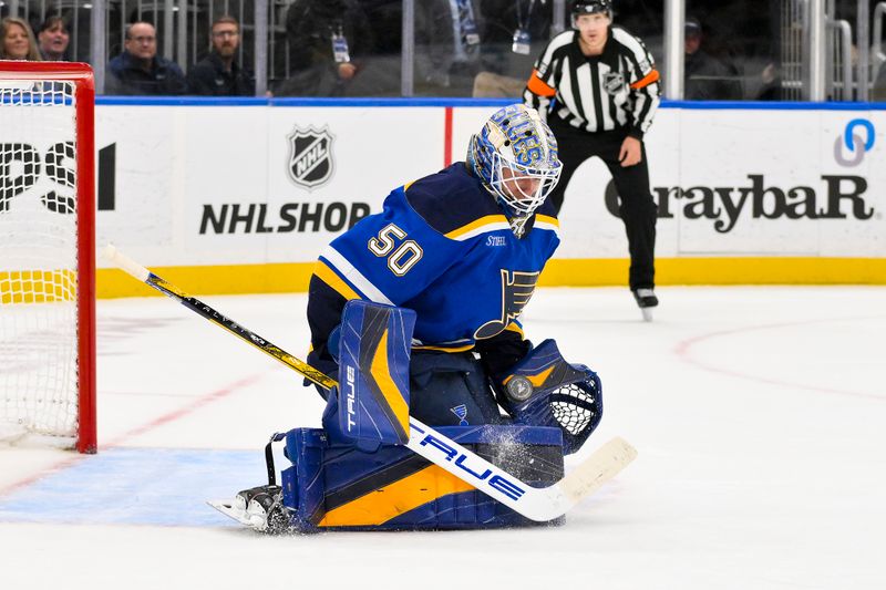 Nov 21, 2024; St. Louis, Missouri, USA;  St. Louis Blues goaltender Jordan Binnington (50) makes a save against San Jose Sharks left wing William Eklund (not pictured) in shootouts at Enterprise Center. Mandatory Credit: Jeff Curry-Imagn Images