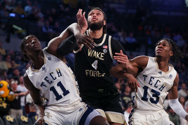 Feb 6, 2024; Atlanta, Georgia, USA; Georgia Tech Yellow Jackets forward Baye Ndongo (11) and guard Miles Kelly (13) box out Wake Forest Demon Deacons forward Efton Reid III (4) in the first half at McCamish Pavilion. Mandatory Credit: Brett Davis-USA TODAY Sports
