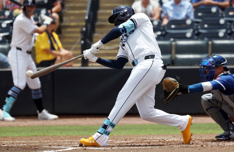 May 1, 2025; St. Petersburg, Florida, USA;  Tampa Bay Rays third base Junior Caminero (13) singles during the second inning against the Kansas City Royals at George M. Steinbrenner Field. Mandatory Credit: Kim Klement Neitzel-Imagn Images