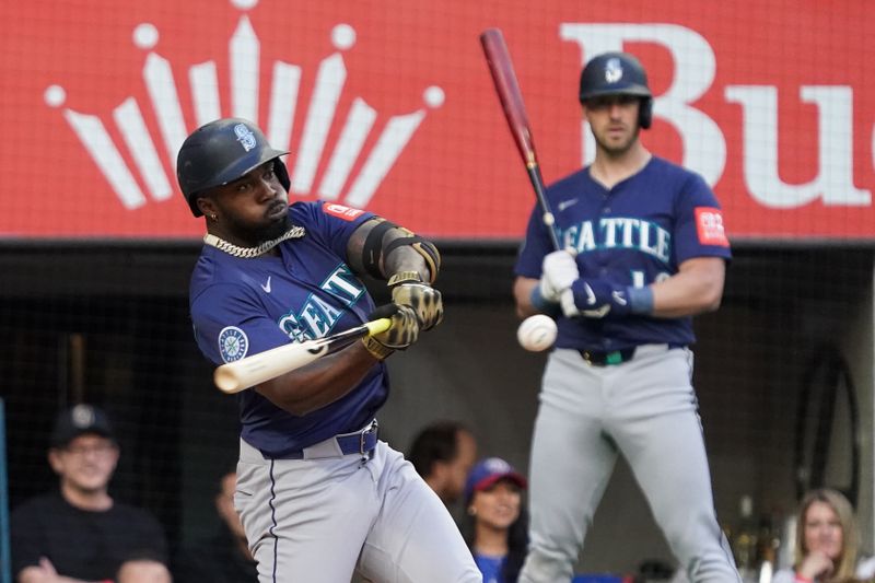 May 3, 2025; Arlington, Texas, USA; Seattle Mariners manager Dan Wilson (6) hits a single during the first inning against the Texas Rangers at Globe Life Field. Mandatory Credit: Raymond Carlin III-Imagn Images