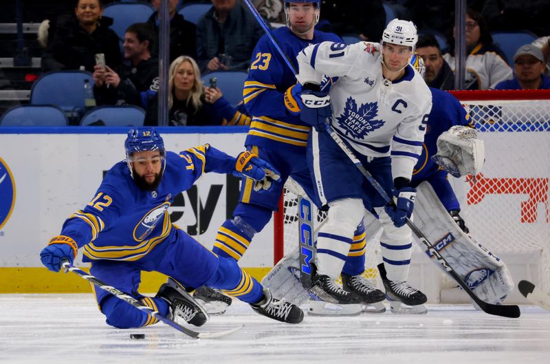 Dec 21, 2023; Buffalo, New York, USA;  Buffalo Sabres left wing Jordan Greenway (12) dives to try and clear the puck during the second period against the Toronto Maple Leafs at KeyBank Center. Mandatory Credit: Timothy T. Ludwig-USA TODAY Sports