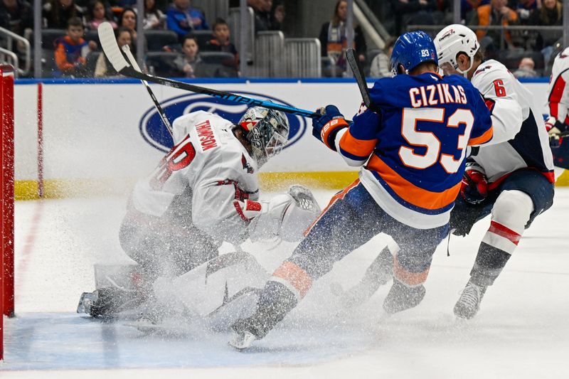 Nov 30, 2025; Elmont, New York, USA;  Washington Capitals goaltender Logan Thompson (48) makes a save as Washington Capitals defenseman Jakob Chychrun (6) defends against New York Islanders center Casey Cizikas (53) during the second period at UBS Arena. Mandatory Credit: Dennis Schneidler-Imagn Images