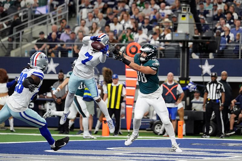 Dallas Cowboys cornerback Trevon Diggs (7) intercepts a pass intended for Philadelphia Eagles tight end Dallas Goedert (88) as safety Malik Hooker (28) looks on in the first half of an NFL football game in Arlington, Texas, Sunday, Nov. 10, 2024. (AP Photo/Julio Cortez)