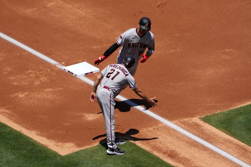 Jul 2, 2023; Anaheim, California, USA; Arizona Diamondbacks catcher Carson Kelly (18) is congratulated by third base coach Tony Perezchica (21) after hitting a two-run home run in the second inning against the Los Angeles Angels at Angel Stadium. Mandatory Credit: Kirby Lee-USA TODAY Sports