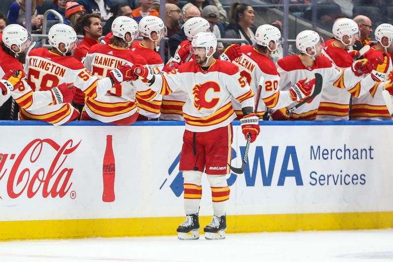 Feb 10, 2024; Elmont, New York, USA;  Calgary Flames defenseman MacKenzie Weegar (52) celebrates with his teammates after scoring a goal in the second period New York Islanders at UBS Arena. Mandatory Credit: Wendell Cruz-USA TODAY Sports