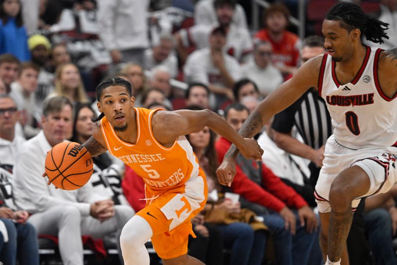 Nov 9, 2024; Louisville, Kentucky, USA;  Tennessee Volunteers guard Zakai Zeigler (5) dribbles against Louisville Cardinals forward James Scott (0) during the first half at KFC Yum! Center. Mandatory Credit: Jamie Rhodes-Imagn Images