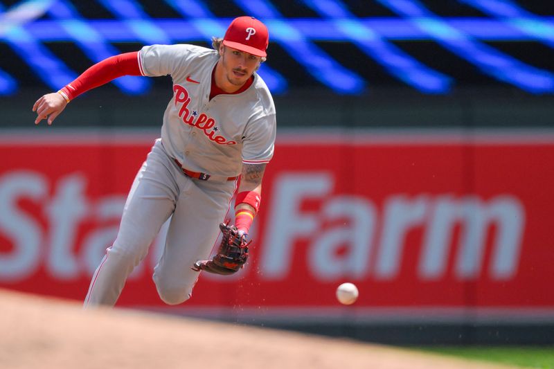 Jul 24, 2024; Minneapolis, Minnesota, USA;  Philadelphia Phillies infielder Bryson Stott (5) fields a ground ball against the Minnesota Twins during the third inning at Target Field. Mandatory Credit: Nick Wosika-USA TODAY Sports