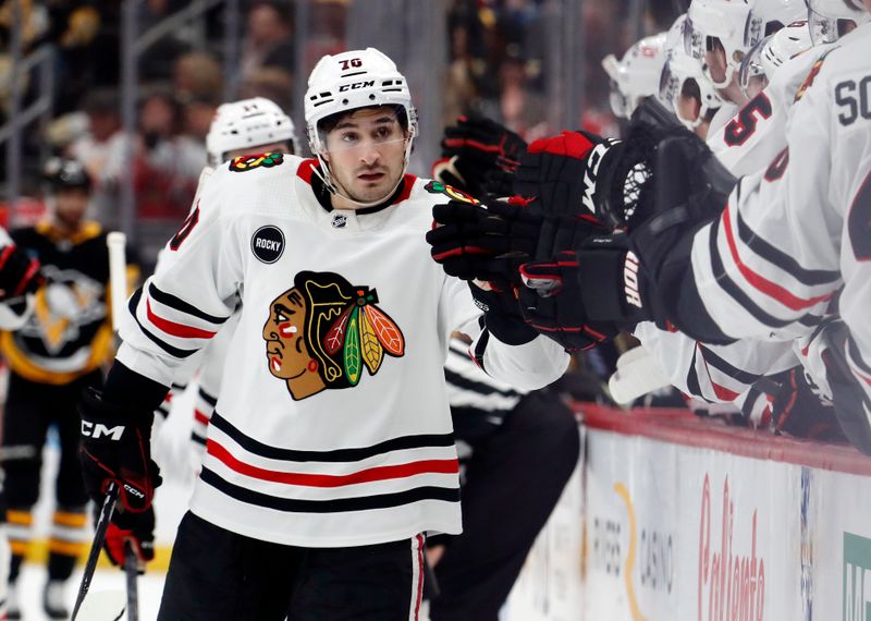 Oct 10, 2023; Pittsburgh, Pennsylvania, USA; Chicago Blackhawks center Cole Guttman (70) celebrates with the Chicago bench after scoring the game winning goal against the Pittsburgh Penguins during the third period at the PPG Paints Arena. Chicago won 4-2. Mandatory Credit: Charles LeClaire-USA TODAY Sports