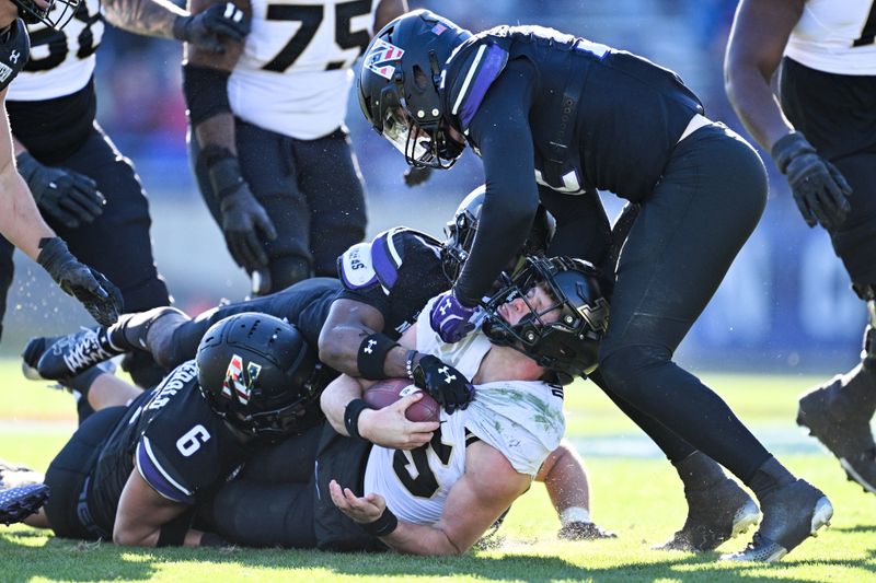 Nov 18, 2023; Evanston, Illinois, USA;  Purdue Boilermakers quarterback Ryan Browne (15) is tackled by the Northwestern Wildcats defense in the fourth quarter at Ryan Field. Mandatory Credit: Jamie Sabau-USA TODAY Sports