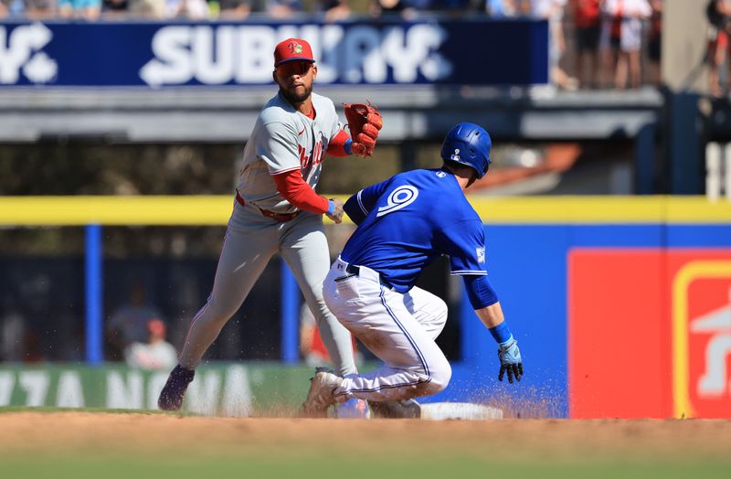 Feb 21, 2026; Dunedin, Florida, USA;  Philadelphia Phillies infielder Edmundo Sosa (33) forces out Toronto Blue Jays outfielder RJ Schreck (9) and throws the ball to first base for a double play during the sixth inning  at TD Ballpark. Mandatory Credit: Kim Klement Neitzel-Imagn Images