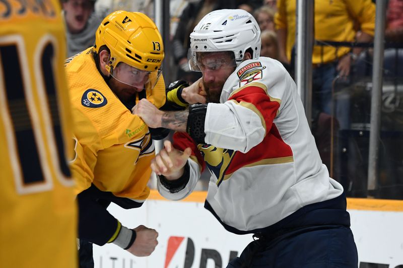 Jan 22, 2024; Nashville, Tennessee, USA; Nashville Predators center Yakov Trenin (13) and Florida Panthers left wing Jonah Gadjovich (12) fight during the second period at Bridgestone Arena. Mandatory Credit: Christopher Hanewinckel-USA TODAY Sports