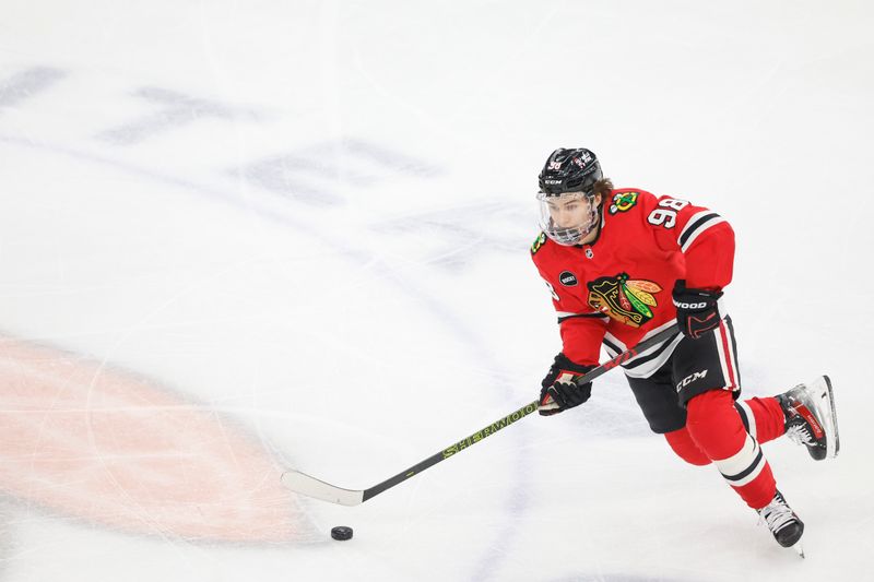 Feb 25, 2024; Chicago, Illinois, USA; Chicago Blackhawks center Connor Bedard (98) controls the puck against the Detroit Red Wings during the first period at United Center. Mandatory Credit: Kamil Krzaczynski-USA TODAY Sports