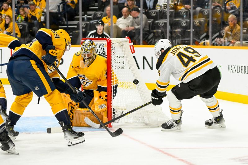 Oct 22, 2024; Nashville, Tennessee, USA; Nashville Predators goaltender Juuse Saros (74) and defenseman Roman Josi (59) block the shot of Boston Bruins left wing Max Jones (49) during the second period at Bridgestone Arena. Mandatory Credit: Steve Roberts-Imagn Images