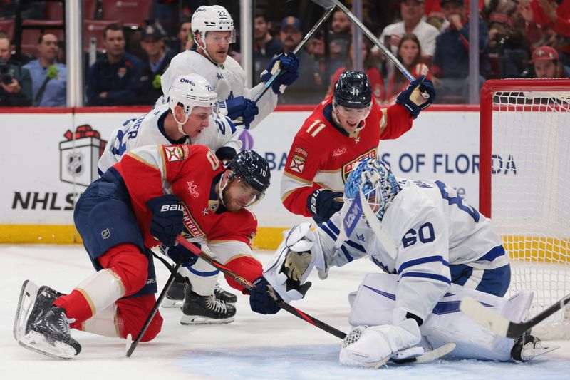 Dec 2, 2025; Sunrise, Florida, USA; Toronto Maple Leafs goaltender Joseph Woll (60) makes a save against Florida Panthers left wing A.J. Greer (10) during the first period at Amerant Bank Arena. Mandatory Credit: Sam Navarro-Imagn Images