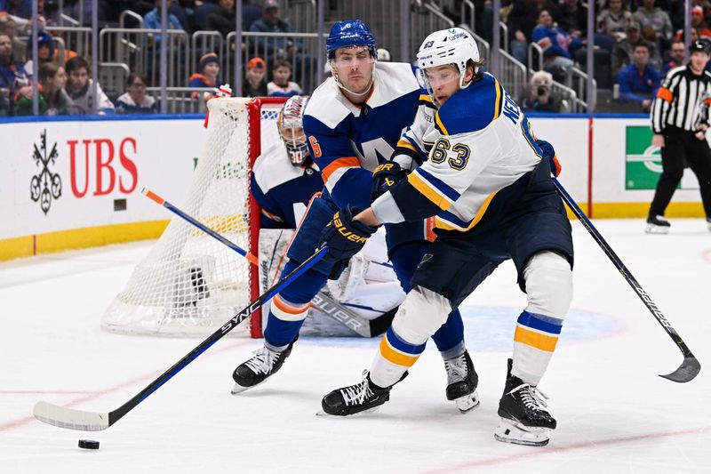 Mar 5, 2024; Elmont, New York, USA;  St. Louis Blues left wing Jake Neighbours (63) controls the puck defended by New York Islanders defenseman Ryan Pulock (6) during the third period at UBS Arena. Mandatory Credit: Dennis Schneidler-USA TODAY Sports