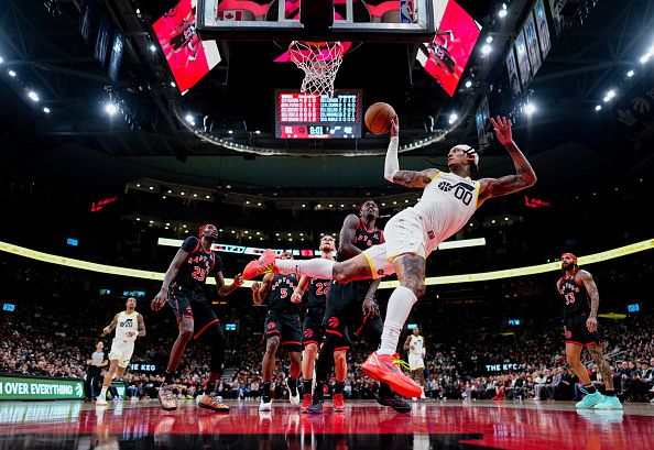 TORONTO, ON - DECEMBER 23: Jordan Clarkson #00 of the Utah Jazz passes the ball off against the Toronto Raptors during the first half of their basketball game at the Scotiabank Arena on December 23, 2023 in Toronto, Ontario, Canada. NOTE TO USER: User expressly acknowledges and agrees that, by downloading and/or using this Photograph, user is consenting to the terms and conditions of the Getty Images License Agreement. (Photo by Mark Blinch/Getty Images)