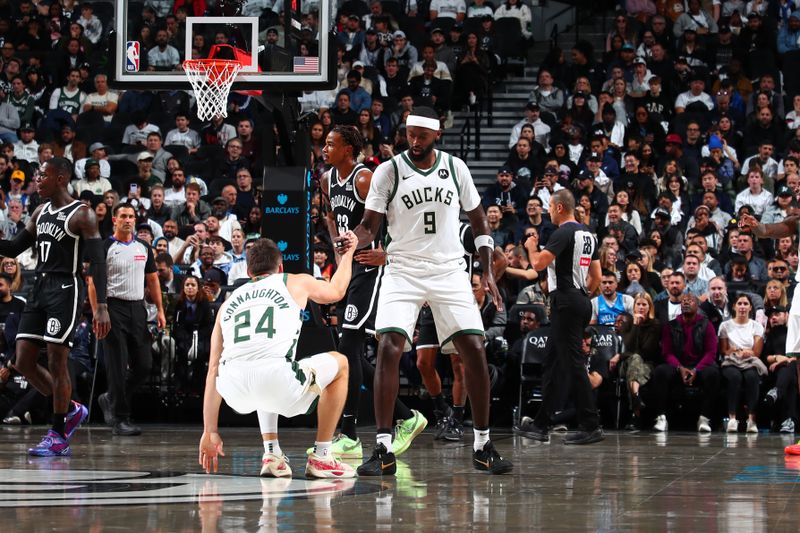 BROOKLYN, NY - OCTOBER 27: Bobby Portis #9 helps up Pat Connaughton #24 of the Milwaukee Bucks during the game against the Brooklyn Nets on October 27, 2024 at Barclays Center in Brooklyn, New York. NOTE TO USER: User expressly acknowledges and agrees that, by downloading and or using this Photograph, user is consenting to the terms and conditions of the Getty Images License Agreement. Mandatory Copyright Notice: Copyright 2024 NBAE (Photo by David L. Nemec/NBAE via Getty Images)