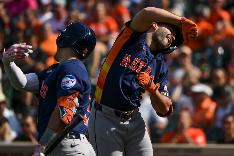 Aug 24, 2024; Baltimore, Maryland, USA;  Houston Astros second baseman Jose Altuve (27) celebrate with a21 after hitting a first inning solo home run against the Baltimore Orioles at Oriole Park at Camden Yards. Mandatory Credit: Tommy Gilligan-USA TODAY Sports