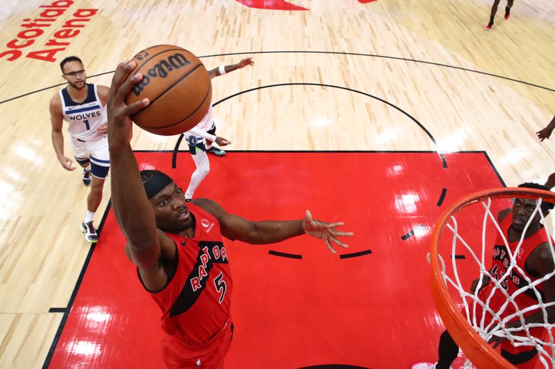 TORONTO, CANADA - OCTOBER 25: Precious Achiuwa #5 of the Toronto Raptors goes to the net for a dunk against the Minnesota Timberwolves during the first half of their NBA game at Scotiabank Arena on October 25, 2023 in Toronto, Canada. NOTE TO USER: User expressly acknowledges and agrees that, by downloading and or using this photograph, User is consenting to the terms and conditions of the Getty Images License Agreement. (Photo by Cole Burston/Getty Images)