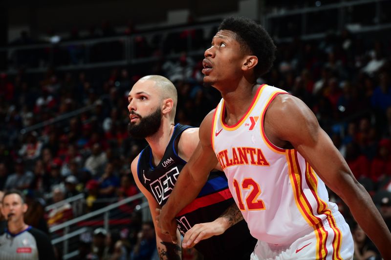 ATLANTA, GA - APRIL 3: Evan Fournier #31 of the Detroit Pistons  and De'Andre Hunter #12 of the Atlanta Hawks wait for a rebound during the game on April 3, 2024 at State Farm Arena in Atlanta, Georgia.  NOTE TO USER: User expressly acknowledges and agrees that, by downloading and/or using this Photograph, user is consenting to the terms and conditions of the Getty Images License Agreement. Mandatory Copyright Notice: Copyright 2024 NBAE (Photo by Scott Cunningham/NBAE via Getty Images)