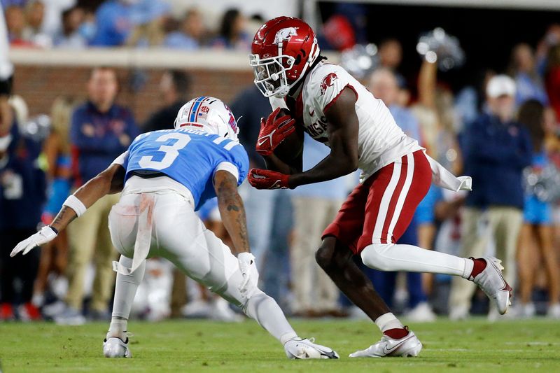 Oct 7, 2023; Oxford, Mississippi, USA; Arkansas Razorbacks wide receiver Andrew Armstrong (2) runs after a catch as Mississippi Rebels defensive back Daijahn Anthony (3) attempts to make the tackle during the first half at Vaught-Hemingway Stadium. Mandatory Credit: Petre Thomas-USA TODAY Sports