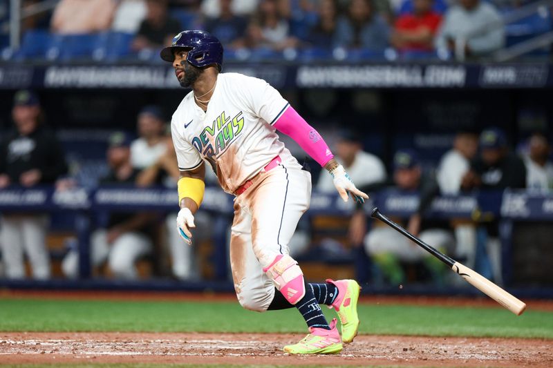 Jul 12, 2024; St. Petersburg, Florida, USA; Tampa Bay Rays first baseman Yandy Diaz (2) singles against the Cleveland Guardians in the seventh inning at Tropicana Field. Mandatory Credit: Nathan Ray Seebeck-USA TODAY Sports