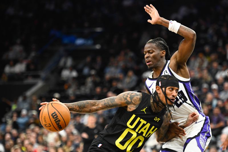 SALT LAKE CITY, UTAH - OCTOBER 29: Jordan Clarkson #00 of the Utah Jazz drives into Keon Ellis #23 of the Sacramento Kings during the second half of a game at Delta Center on October 29, 2024 in Salt Lake City, Utah. NOTE TO USER: User expressly acknowledges and agrees that, by downloading and or using this photograph, User is consenting to the terms and conditions of the Getty Images License Agreement.  (Photo by Alex Goodlett/Getty Images)