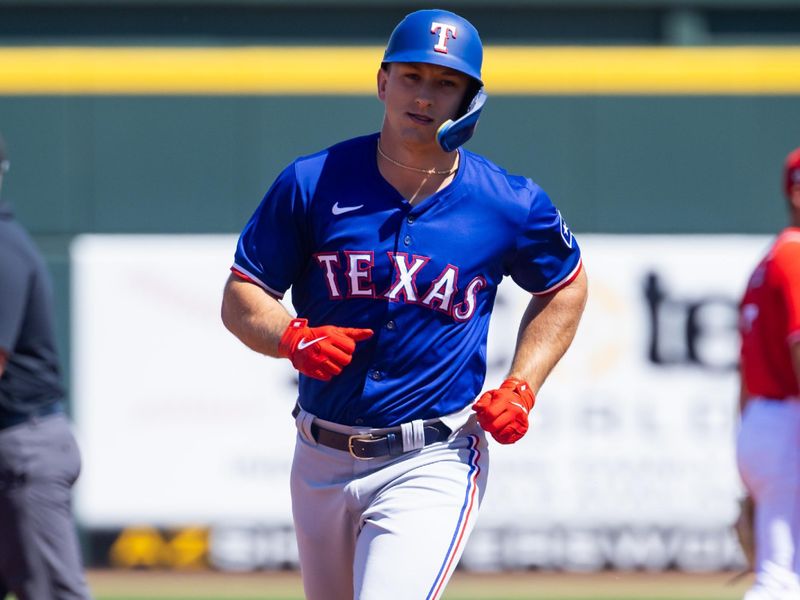 Mar 20, 2024; Goodyear, Arizona, USA; Texas Rangers outfielder Wyatt Langford rounds the bases after hitting a home run against the Cincinnati Reds during a spring training baseball game at Goodyear Ballpark. Mandatory Credit: Mark J. Rebilas-USA TODAY Sports
