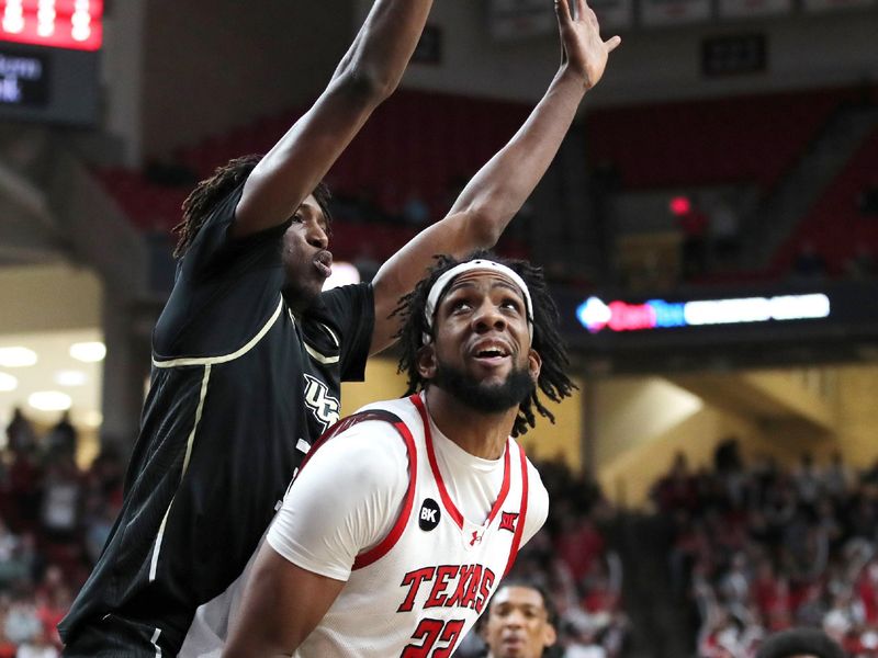 Feb 10, 2024; Lubbock, Texas, USA;  Texas Tech Red Raiders forward Warren Washington (22) stops to shoot against Central Florida Knights forward Thierno Sylla (31) in the second half at United Supermarkets Arena. Mandatory Credit: Michael C. Johnson-USA TODAY Sports