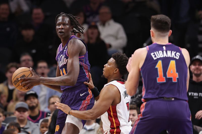 PHOENIX, ARIZONA - JANUARY 05:  Bol Bol #11 of the Phoenix Suns looks to pass under pressure from Kyle Lowry #7 of the Miami Heat during the first half of the NBA game at Footprint Center on January 05, 2024 in Phoenix, Arizona.  The Suns defeated the Heat 113-97.  NOTE TO USER: User expressly acknowledges and agrees that, by downloading and or using this photograph, User is consenting to the terms and conditions of the Getty Images License Agreement.  (Photo by Christian Petersen/Getty Images)