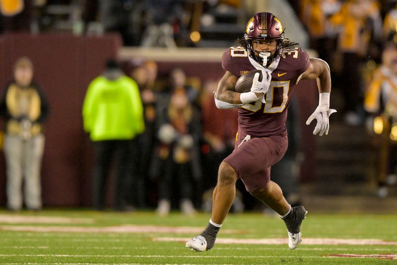 Nov 25, 2023; Minneapolis, Minnesota, USA; Minnesota Golden Gophers running back Jordan Nubin (30) runs with the ball against the Wisconsin Badgers during the fourth quarter at Huntington Bank Stadium. Mandatory Credit: Nick Wosika-USA TODAY Sports